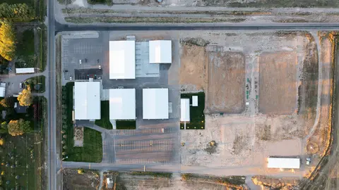 An aerial view of commercial buildings and parking lots.