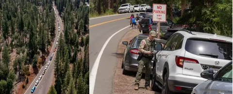 An aerial view of a line of cars parked along a forest highway and a ranger writing a ticket next to parked cars.