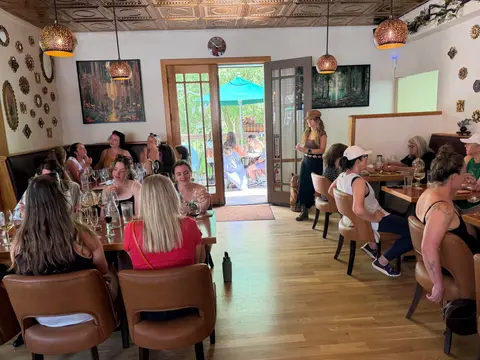 A group of people sitting inside a restaurant.