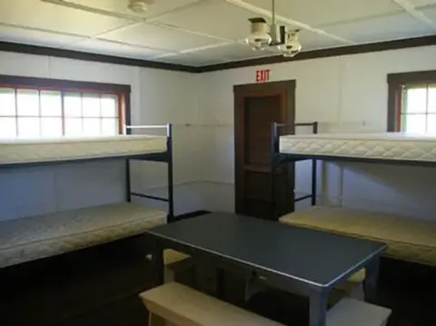 An interior room with bunk beds and a table.