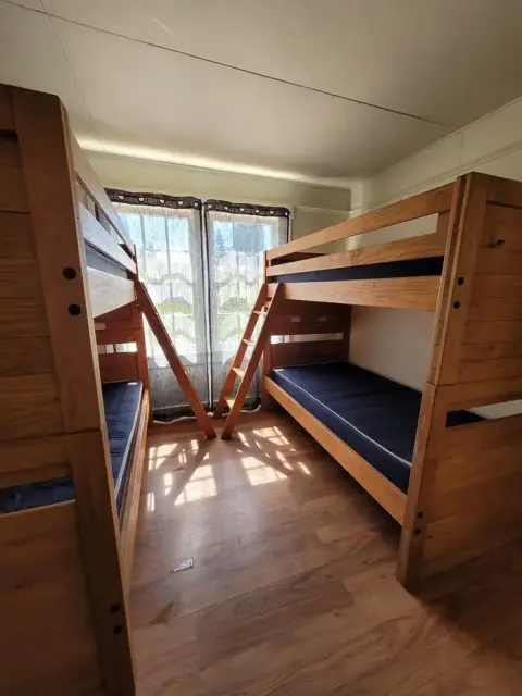 An interior view of a room with two wooden bunk beds.