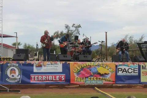 A band performs on an outdoor stage at a fall festival.