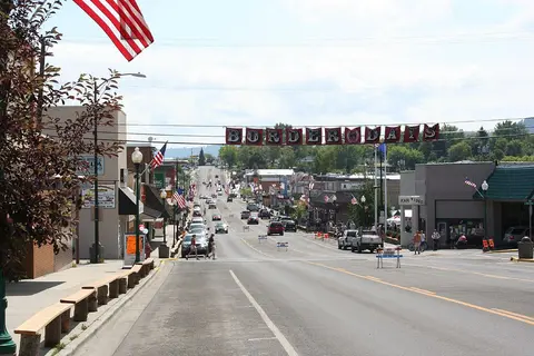 A street in a town decorated with flags and a banner that reads BORDER DAYS.