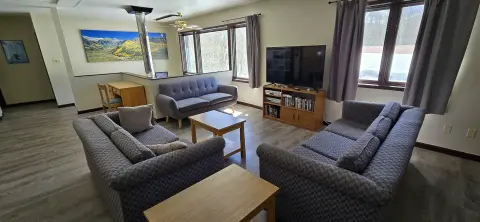 An interior shot of a living room with couches and a television.