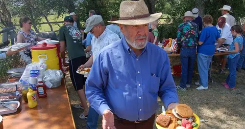 A group of people gathered for an outdoor buffet meal.