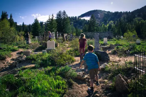 People walking through a mountain cemetery.
