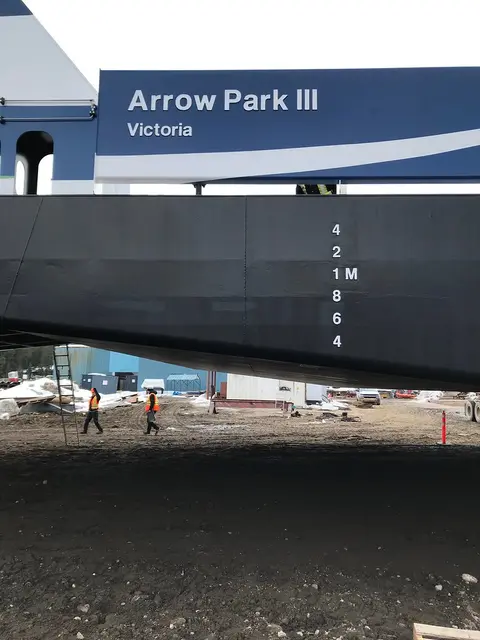 A large vessel section marked Arrow Park III under construction outdoors.
