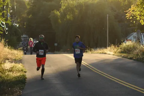 Two runners participate in a road race.