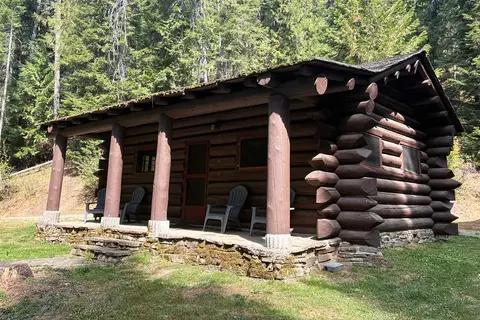A log cabin nestled in a forest.