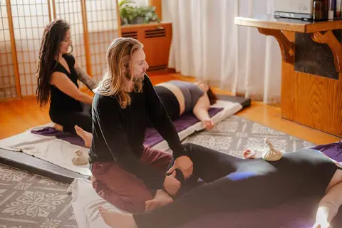 People receiving massage therapy indoors.