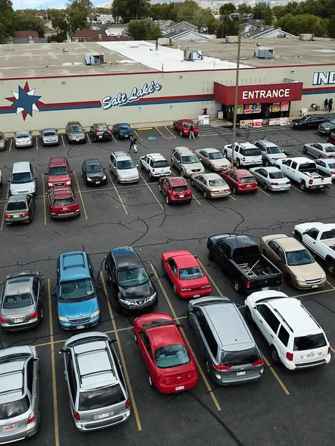 An aerial view of a parking lot outside a building with an entrance.