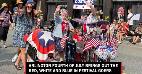 People dressed in patriotic gear wave during a parade.