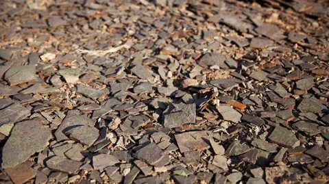 A close-up shot of shattered pieces of rock covering the ground.