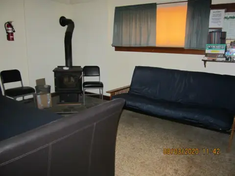An interior room with a wood stove and seating.