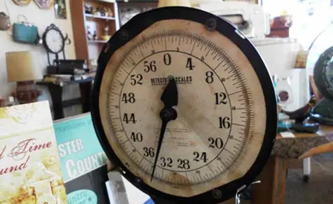 A vintage scale face inside a shop.