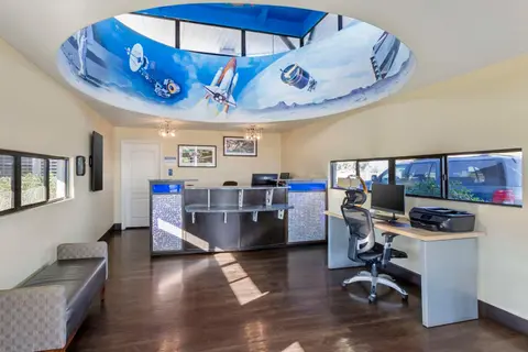 An interior view of an office with a space-themed ceiling mural.