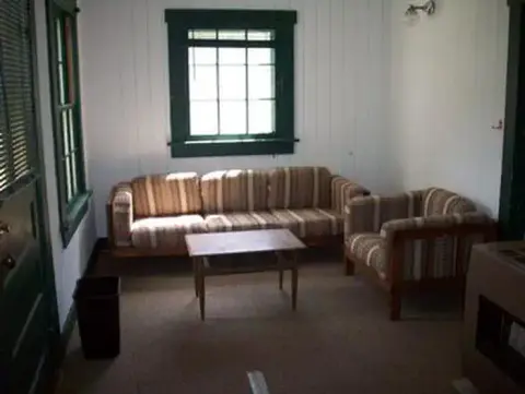 An interior room with a sofa, armchair, and a small coffee table.