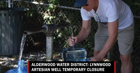A man fills water jugs at an outdoor water spout.