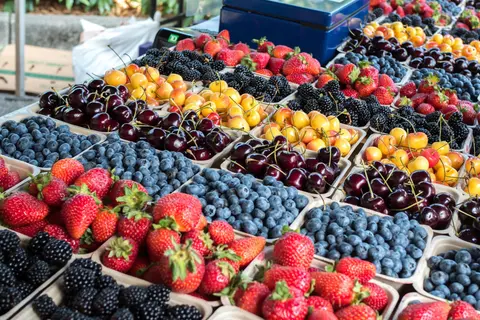 A display of fresh berries at a market stall.