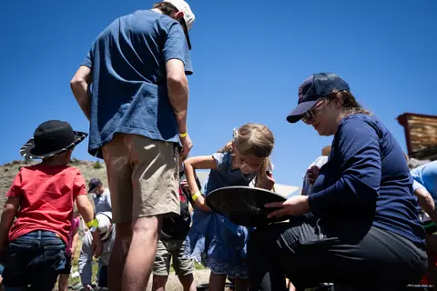 People participate in an outdoor activity under a clear blue sky.