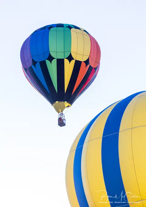 Two hot air balloons fly in the sky.