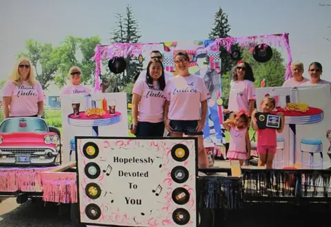 A group of people posing on a themed float outdoors.