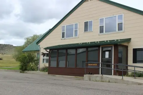 Exterior view of a visitor center building with a ramp.