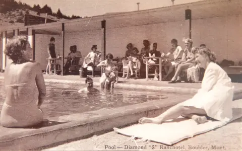 Historic photo of people lounging around a pool at a ranch hotel.