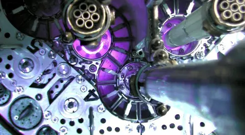 A close-up view of complex mechanical machinery with purple glowing components.
