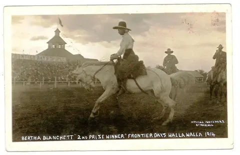 A historic photograph of a rider on a horse at a frontier event.