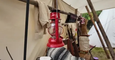 A red lantern hanging inside a canvas tent.