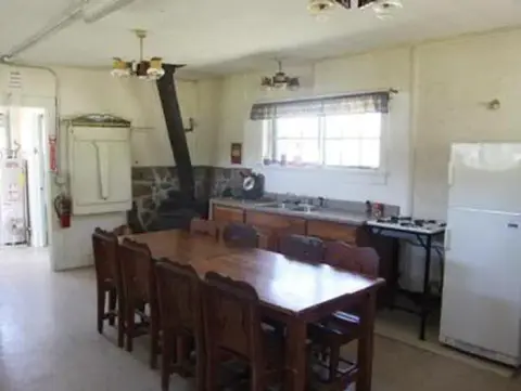 A photo of a rustic kitchen and dining room interior.