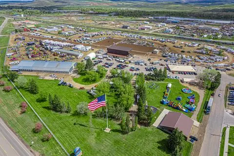 An aerial view of a large outdoor fairgrounds area with an American flag.