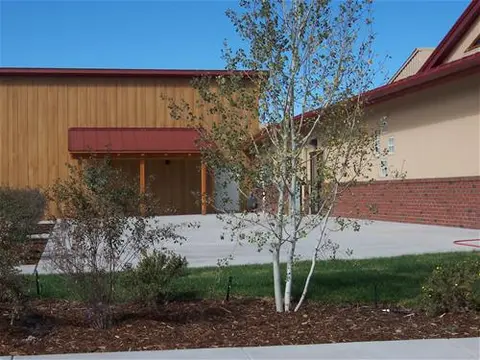 An exterior view of a building with a courtyard and landscaping.