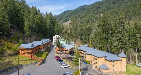 A resort complex nestled in a heavily forested mountain valley.