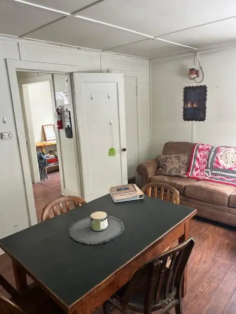 An interior room with a dining table and sofa.