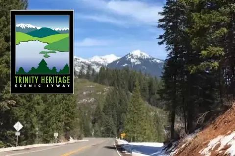 A scenic highway winding through a mountainous landscape with a superimposed graphic.