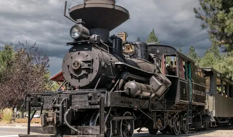 A historic steam locomotive parked outdoors.