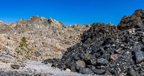A rocky mountain landscape under a clear blue sky.
