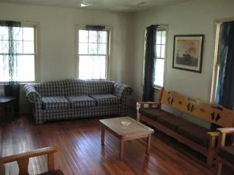An interior room with a sofa, a wooden bench, and a coffee table.