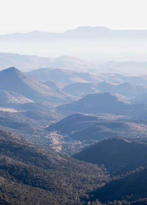 An elevated view of hazy mountains and valleys.