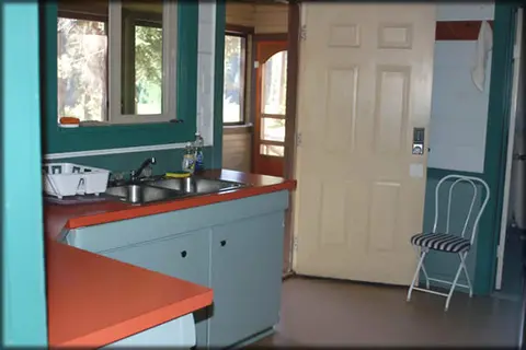An interior view of a room with a kitchen counter and a door.
