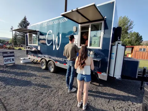 Customers ordering food at a food truck named The Chuckwagon.