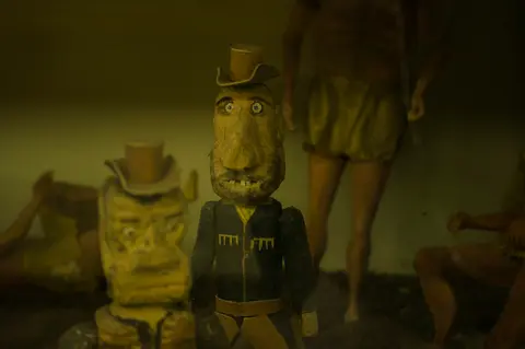 Carved wooden figures at The Thing.