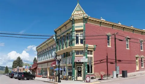 An exterior view of a historic brick commercial building on a sunny day.