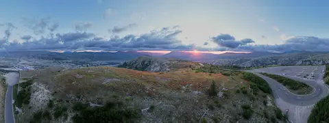 Panoramic view of a mountainous landscape during sunset.