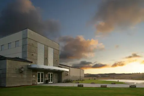 Exterior view of a modern building at sunset.