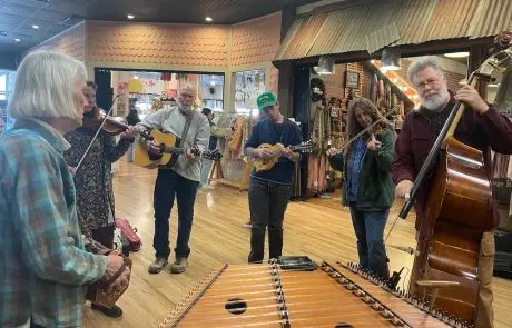 A group of people playing musical instruments inside a building.
