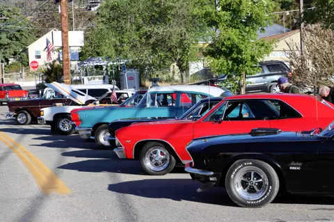 A row of classic cars parked along a street.
