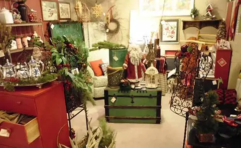 An interior view of a room filled with holiday decor and furniture.